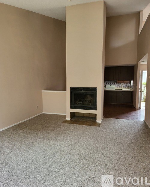 A living room with a fireplace and a television.