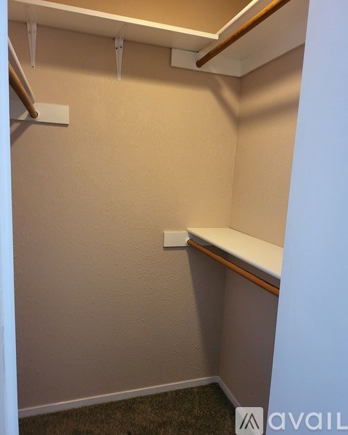 A small, empty room with a light switch on the wall.