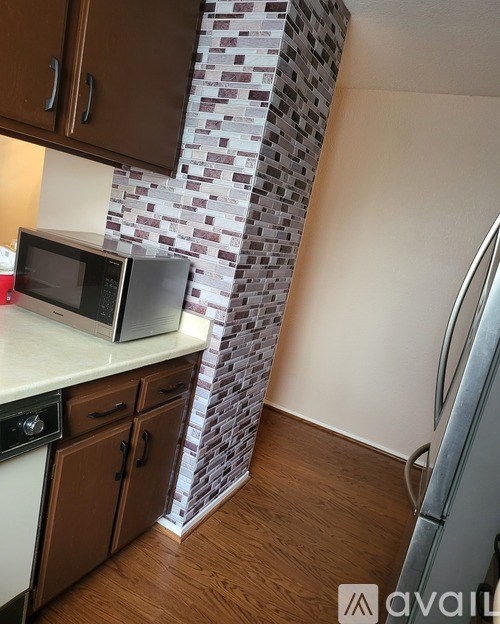 A kitchen with a microwave and oven on the counter.