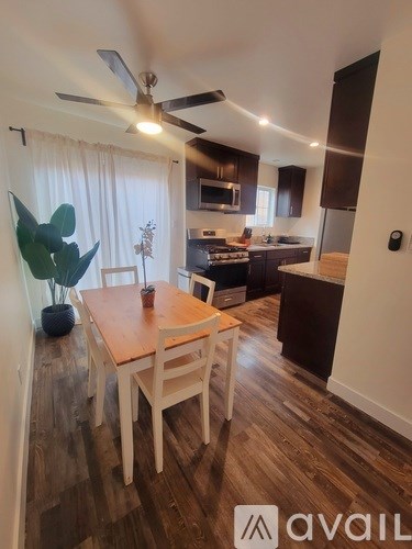 A kitchen with a table and chairs in the middle of the room.