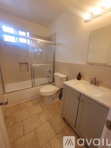A bathroom with a toilet, sink, and shower.