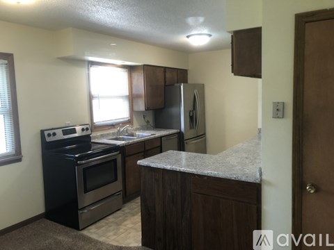 A kitchen with a black stove top oven and a black refrigerator.