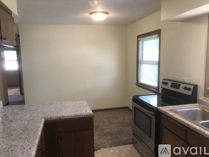 A kitchen with granite countertops and stainless steel appliances is available for rent.