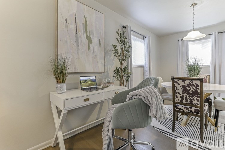 A white desk with a laptop and a plant on it.