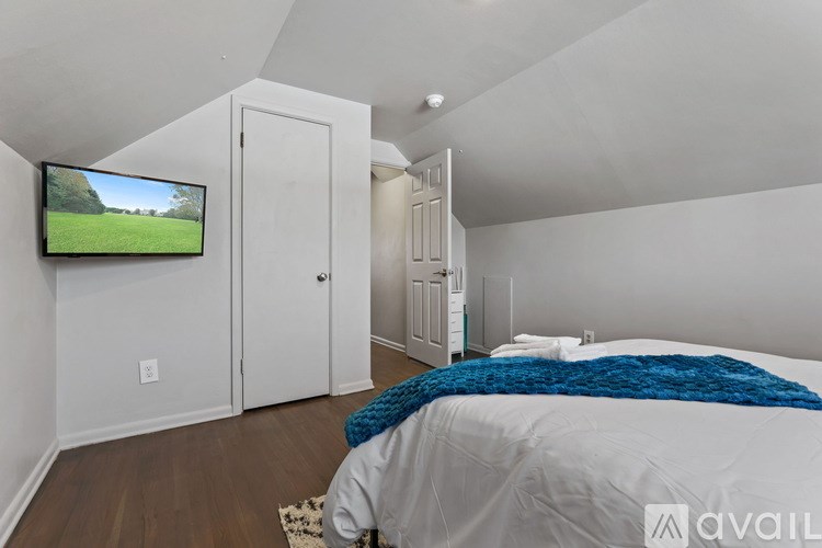 A bedroom with a bed, a television, and a cabinet.