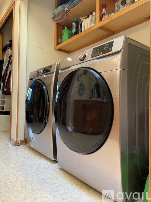 Two front loading washing machines in a laundry room.