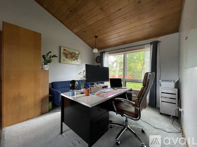 A room with a desk and a chair.