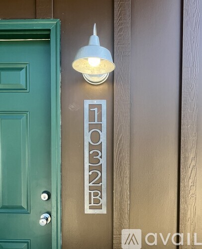 A wall mounted light fixture with the number 1032B on it.