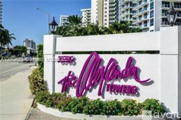 A sign for the Windsor Hotel is displayed in front of a building.