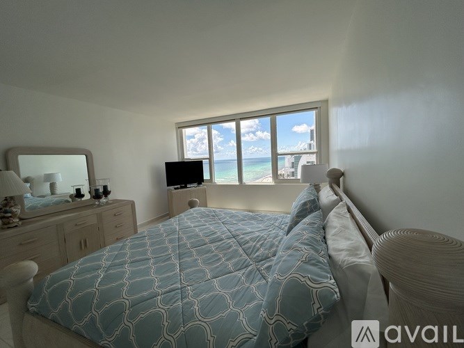 A bedroom with a large bed and a television.