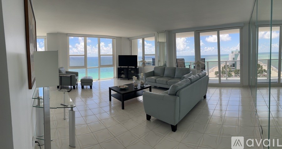 A living room with a view of the beach.