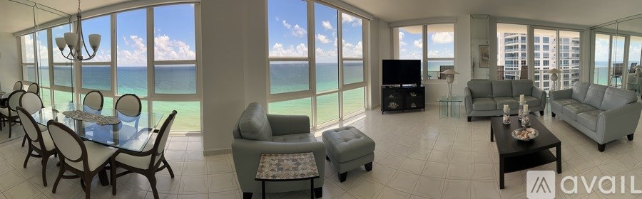 A living room with a view of the ocean.