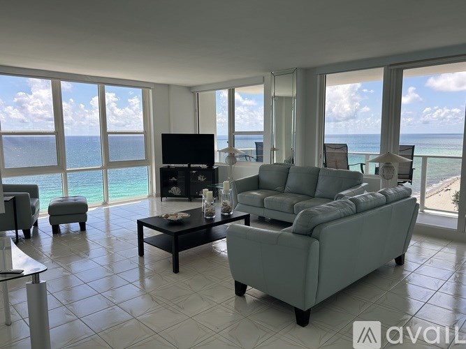 A living room with a large couch and a television.