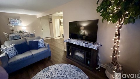 A living room with a grey couch and a television.