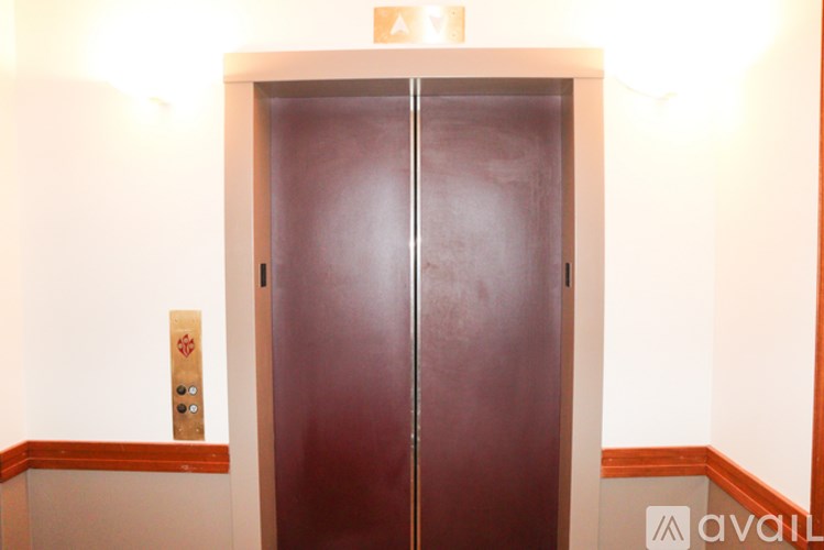 A brown door with a sign above it.
