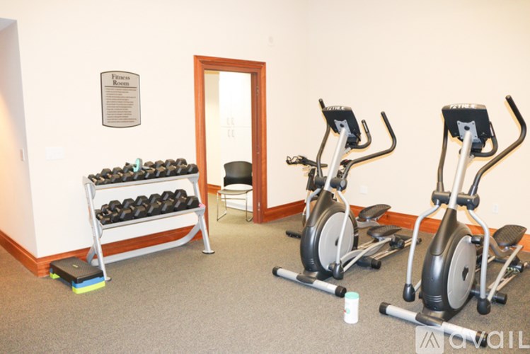 A room with exercise equipment and a dumbbell rack.