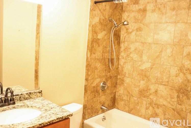 A bathroom with a shower, sink, and toilet.