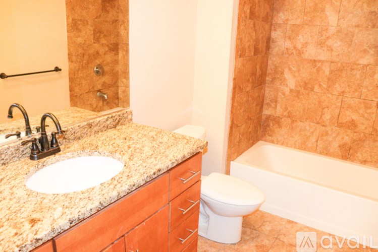 A bathroom with a sink, toilet and bathtub.