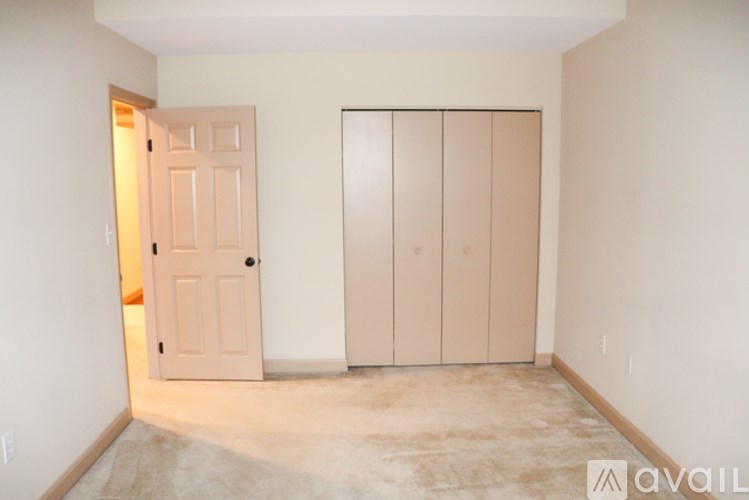 A room with a door and a wardrobe in it.
