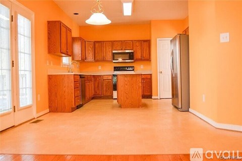A kitchen with wooden cabinets and a refrigerator.