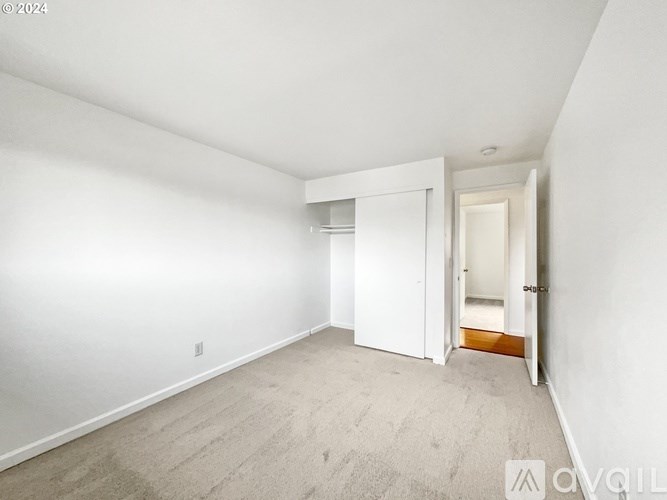 A white room with a doorway leading to another room.