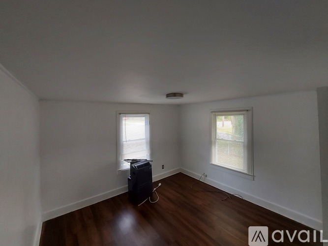 A small room with two beds and a desk.
