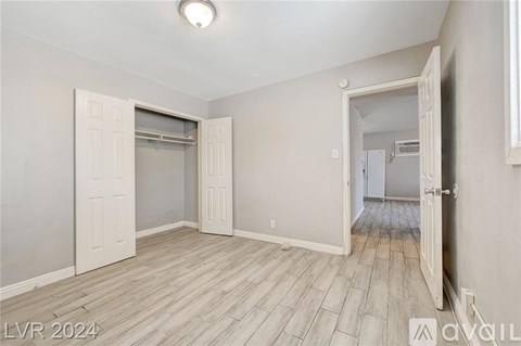 A room with a sliding door and a mirror on the wall.