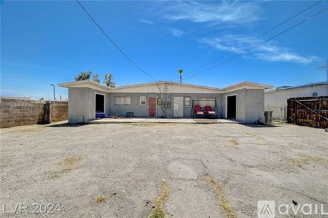 A building with a sign "available" in the foreground and a clear blue sky above.