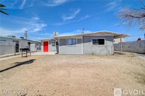 A house with a red door is for sale in 2024.