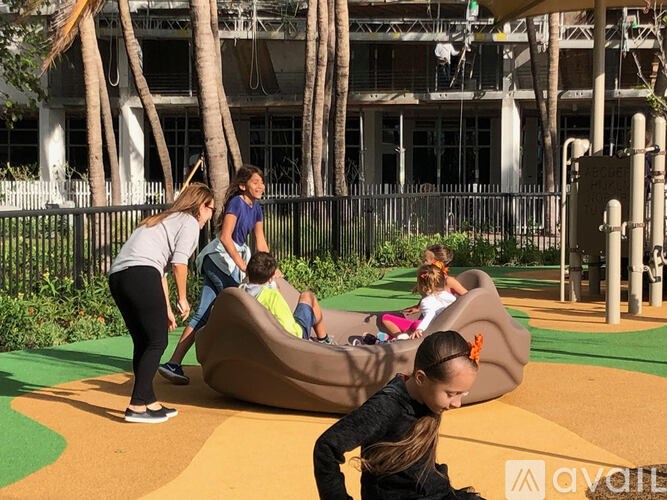A group of children playing on a slide at a playground.