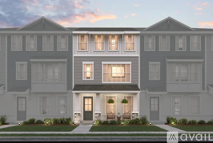 A row of modern townhouses with front yards and landscaping.