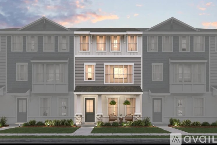 A row of modern townhouses with front yards and landscaping.