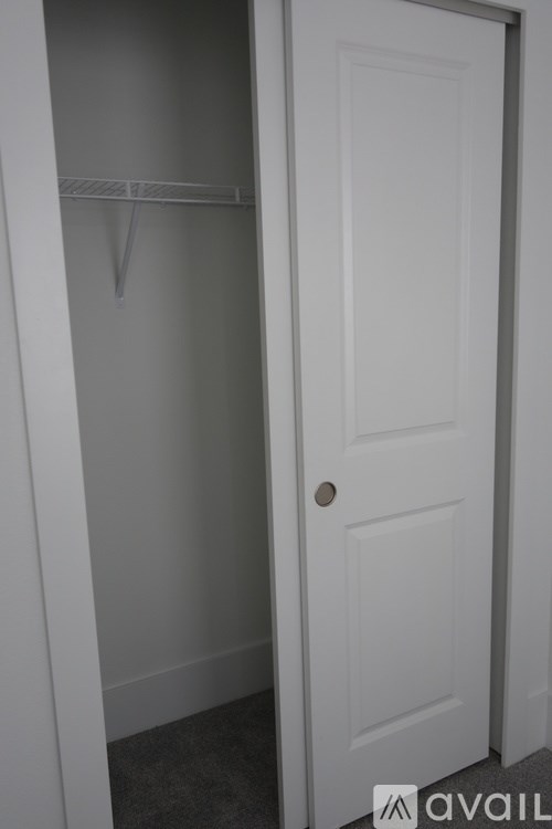 A white door with a shelf above it.