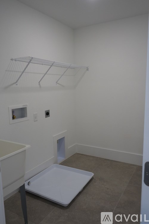 A white room with a bed and a small table.