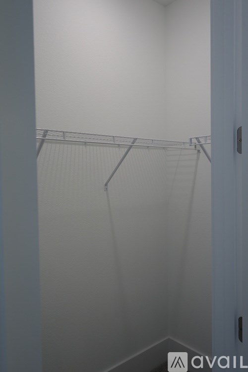 A white room with a metal rack on the wall.