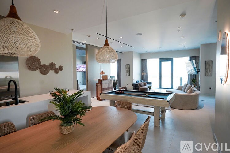 A modern dining room with a wooden table and chairs.