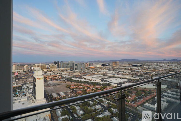 A view of a city from a high vantage point with a tall white tower in the foreground.