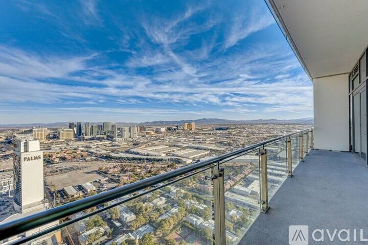 A balcony overlooks a cityscape with the Palms Casino Resort in the distance.