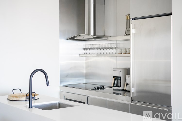 A modern kitchen with a sink and a stove top.
