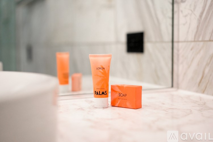 A tube of L'Oreal Paris Palms Soap sits on a marble countertop.