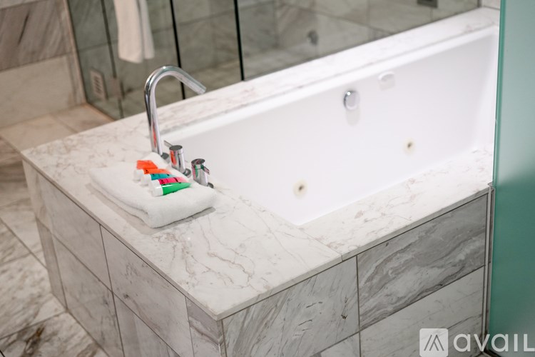 A white bathtub with a faucet and a towel on it.