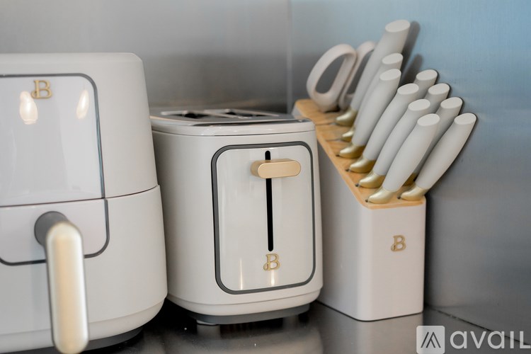 A toaster and a toaster oven with a set of knives on a rack.