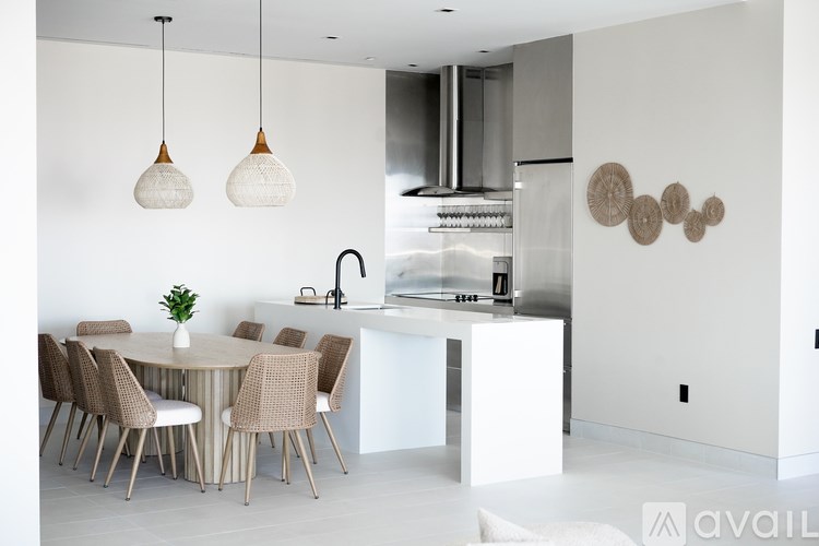 A modern kitchen with a dining table and chairs.
