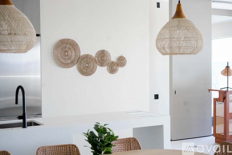 A kitchen with a white wall and a black faucet.