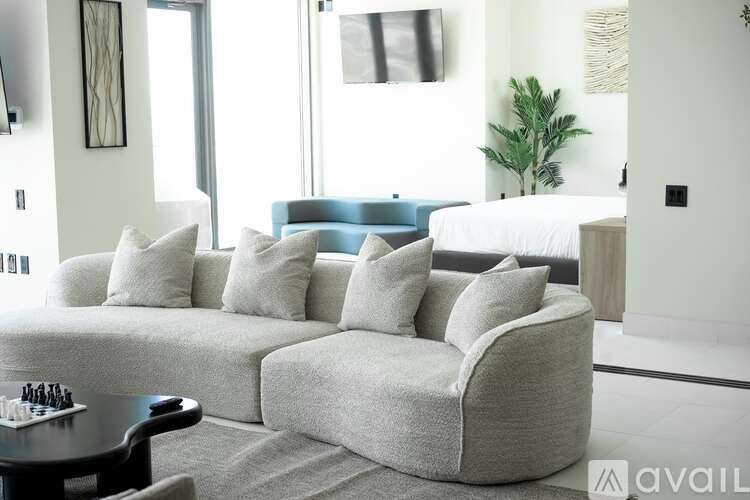 A modern living room with a grey sofa and a black coffee table.