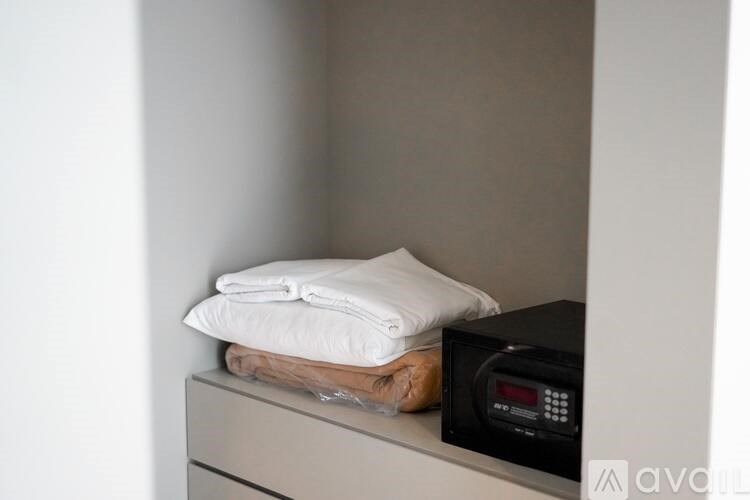 A towel is placed on top of a microwave.