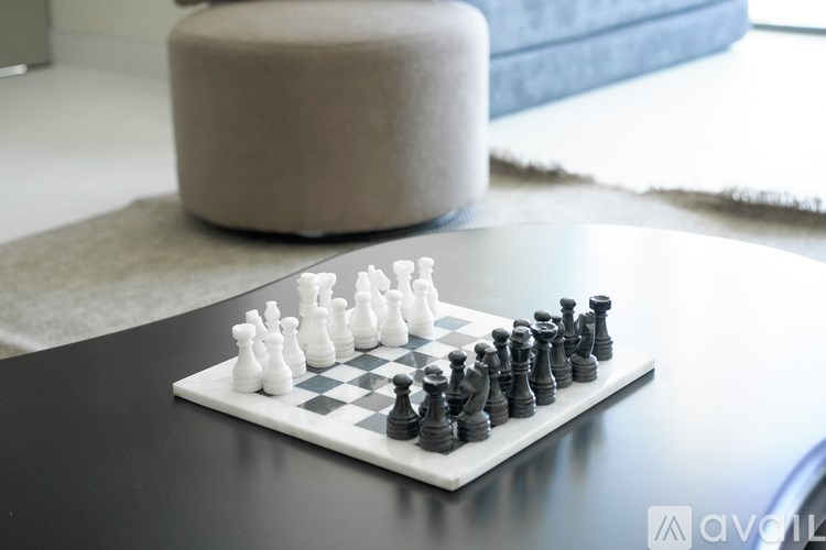 A chessboard with a black pawn and white pawns in the middle of a game.