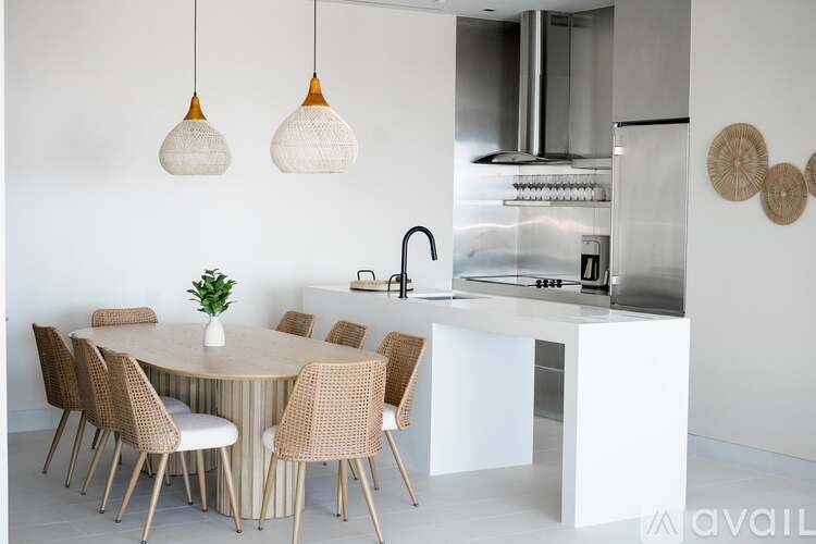 A modern kitchen with a round table and chairs.
