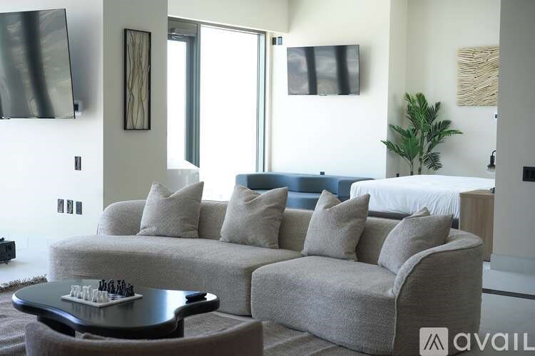 A living room with a grey couch and a coffee table.