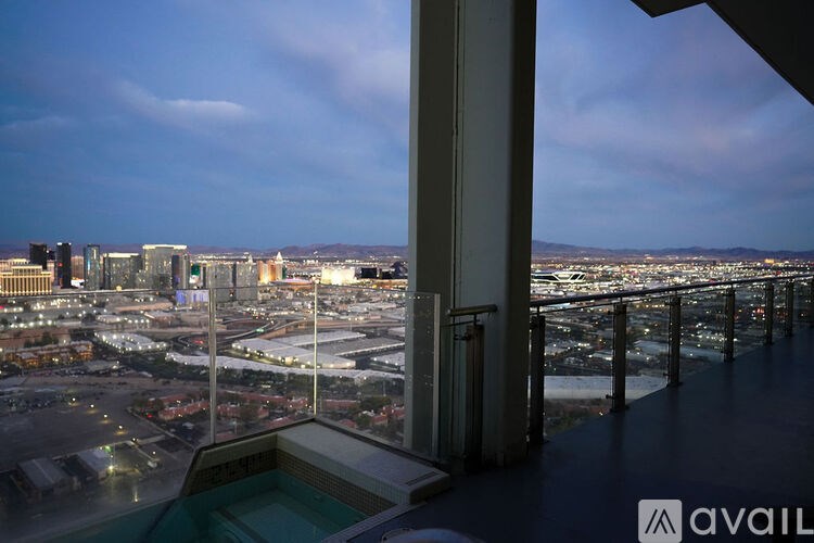 A cityscape is visible from a high vantage point at dusk.